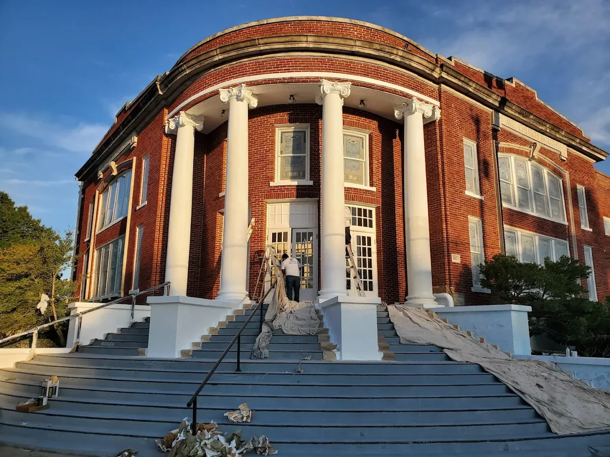 Freshly painted white columns on a historic brick building