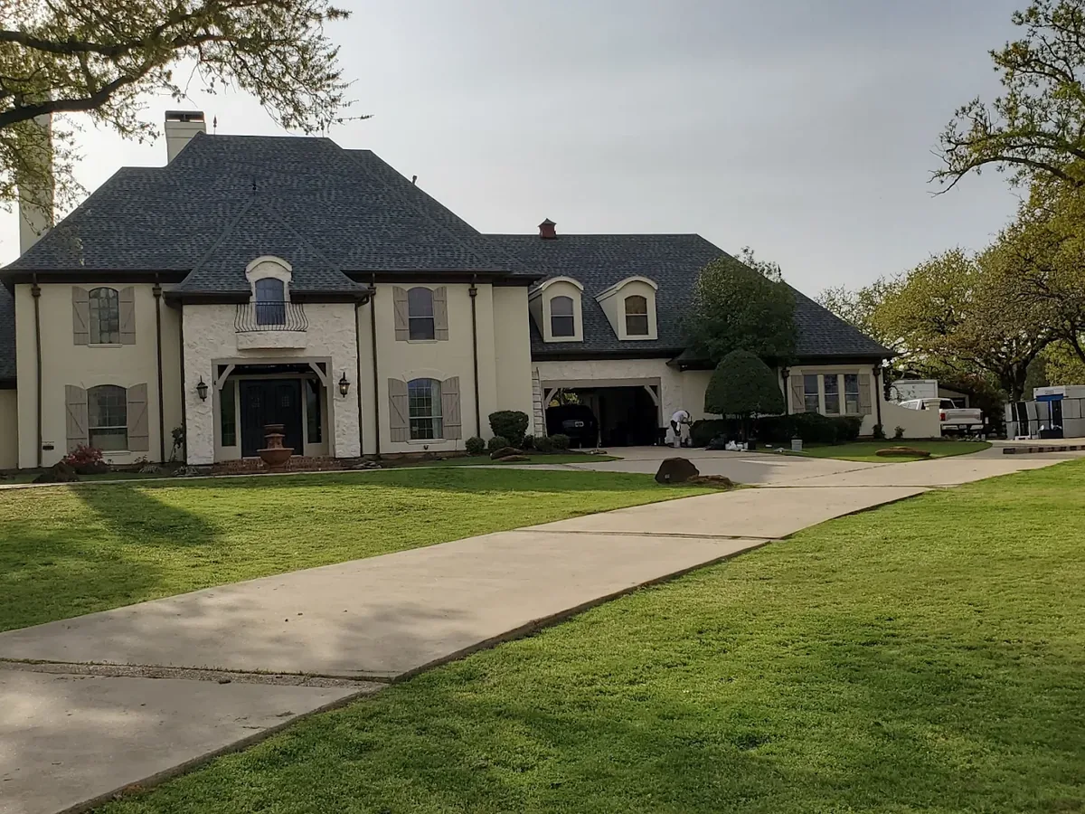 Stucco and stone two story home exterior repaint in Plano, Texas